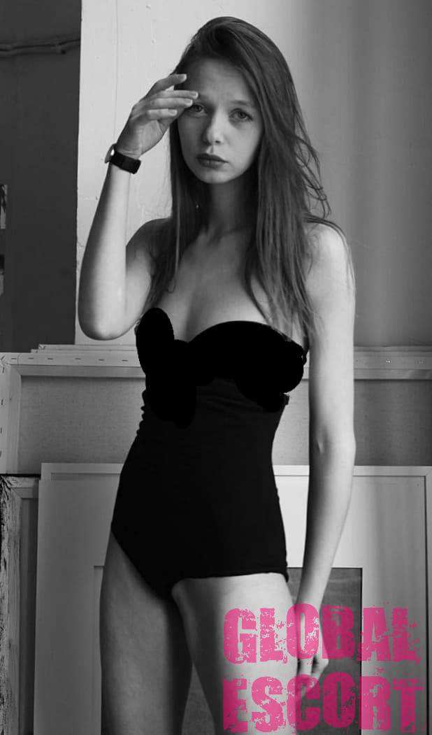 escort model Svetlana in black lingerie posing at a photo shoot in the room