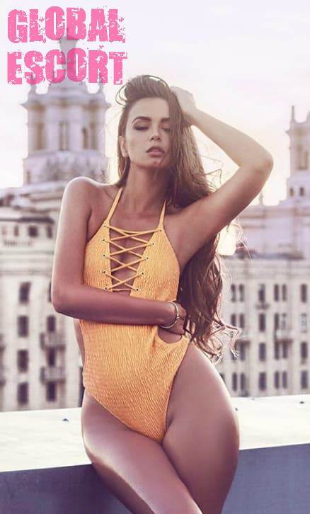 young sexy ukrainian model posing in a yellow swimsuit on the balcony