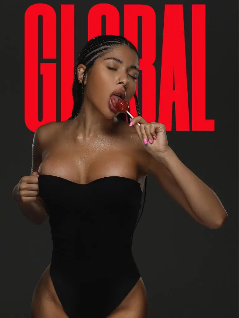 Curvy ebony elite escort model seductively licking lollipop in black bodysuit, providing luxury companion services in Miami and Paris for premium GFE experiences.