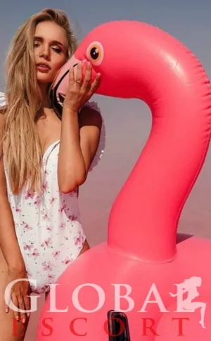 Sexy Model in a white swimsuit with a pink flamingo